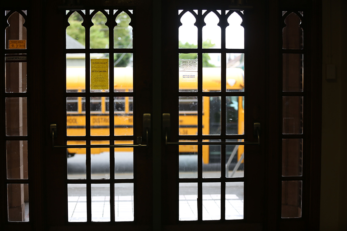 Outside the front doors of McCarver Elementary, a school bus waits to shuttle students home.