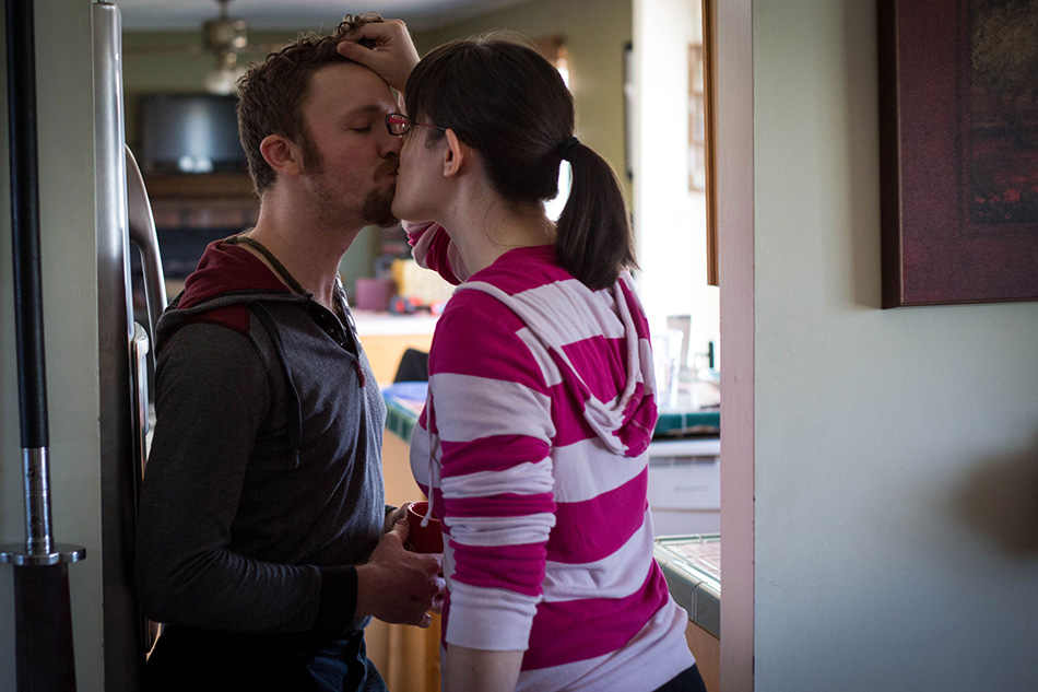 Elise and her husband kiss in their home
